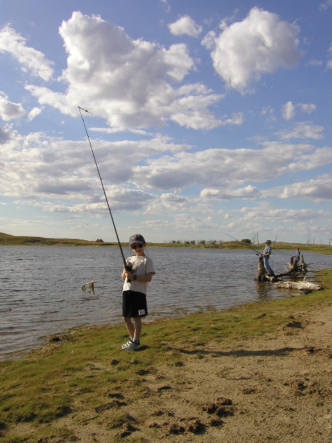 8/13/02 5:08  PM - Owen with the first catch of the day - a little perch!